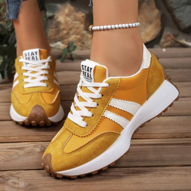 Damskie sneakersy retro na platformie w dynamicznej pozie. Ukazują styl, wygodę i jakość wykonania.