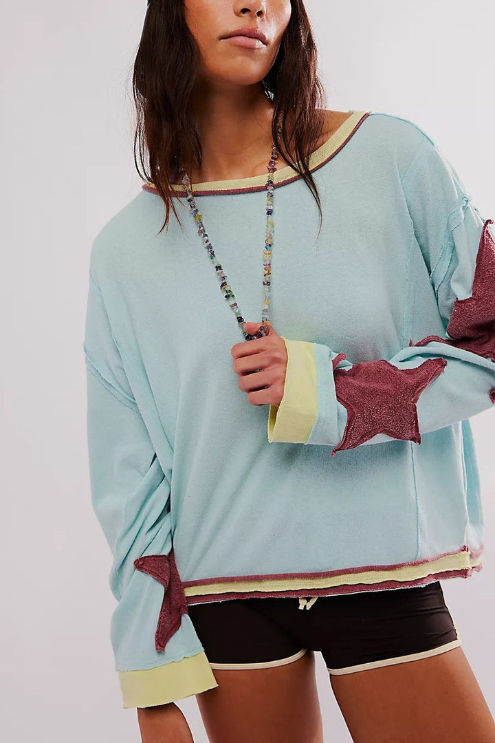 Casualowa bluza damska oversize z gwiazdą. Długi rękaw, modny okrągły dekolt, styl na jesień.