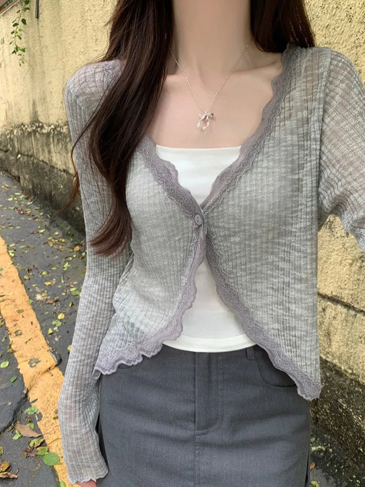 Elegancki koronkowy krótki top damski z guzikiem, modna propozycja do dziennych stylizacji.