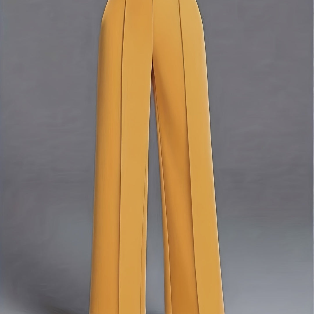 Modelka prezentuje eleganckie damskie spodnie z wysokim stanem i szerokimi nogawkami.