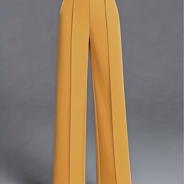 Modelka prezentuje eleganckie damskie spodnie z wysokim stanem i szerokimi nogawkami.