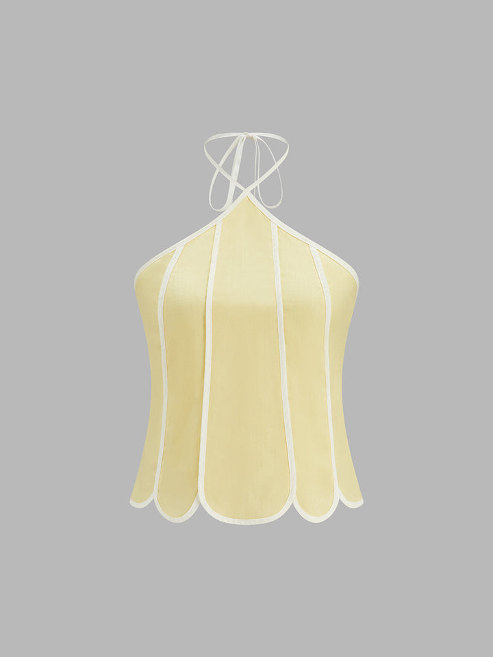 Elegancki jasnożółty komplet damski: kobiecy top halter i zwiewna spódnica midi. Na randkę.