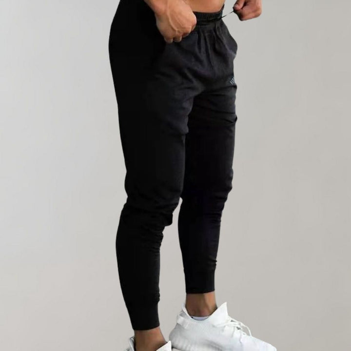Uniwersalne męskie spodnie dresowe slim fit, bawełniane, na wiosnę, do fitnessu i relaksu.