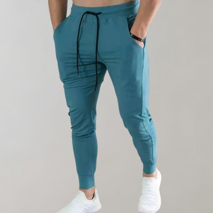 Eleganckie męskie spodnie dresowe slim fit z bawełny, sportowy styl do biegania i na co dzień.