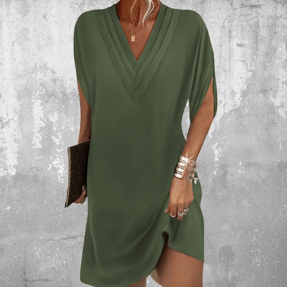 Modelka w eleganckiej pomarańczowej sukience midi V-neck. Letnia, komfortowa odzież damska.