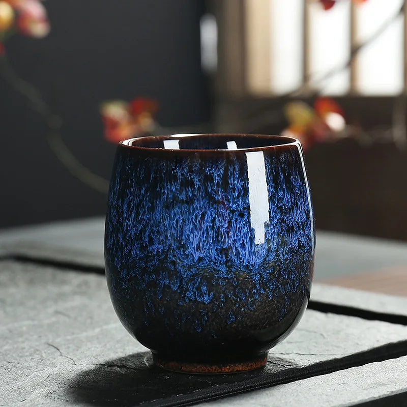 Kubek ceramiczny Kōkei 150ml z ręcznie malowanym wzorem na stole, idealny do serwowania herbaty.