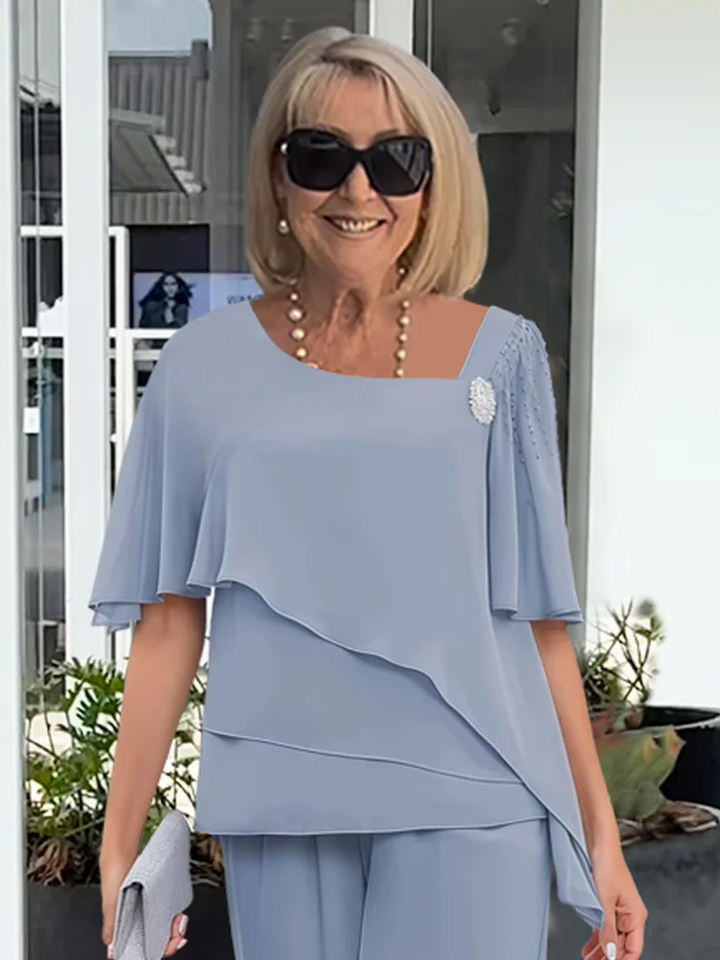 Elegancki damski komplet szyfonowy: bluzka i szerokie spodnie, idealny na wizytowe spotkania.
