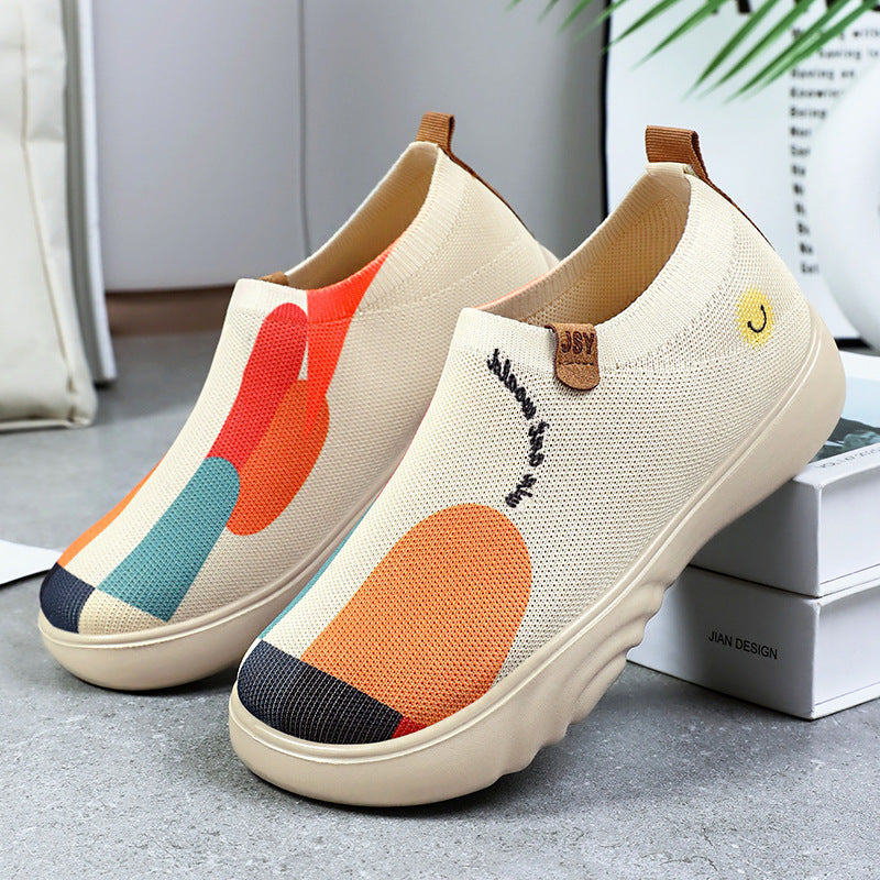 Kremowobiałe sneakersy damskie z pomarańczowym haftem, lekkie i komfortowe buty bez wiązania.