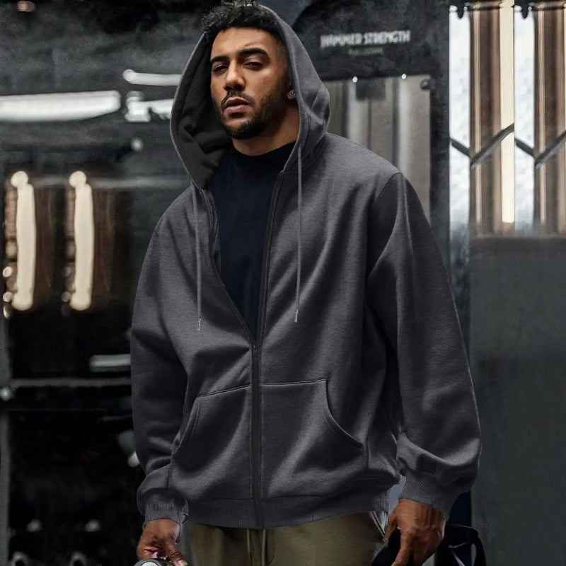 Widok boczny: męska bluza oversize z kapturem na zamek, luźny, wygodny krój do streetwearu.