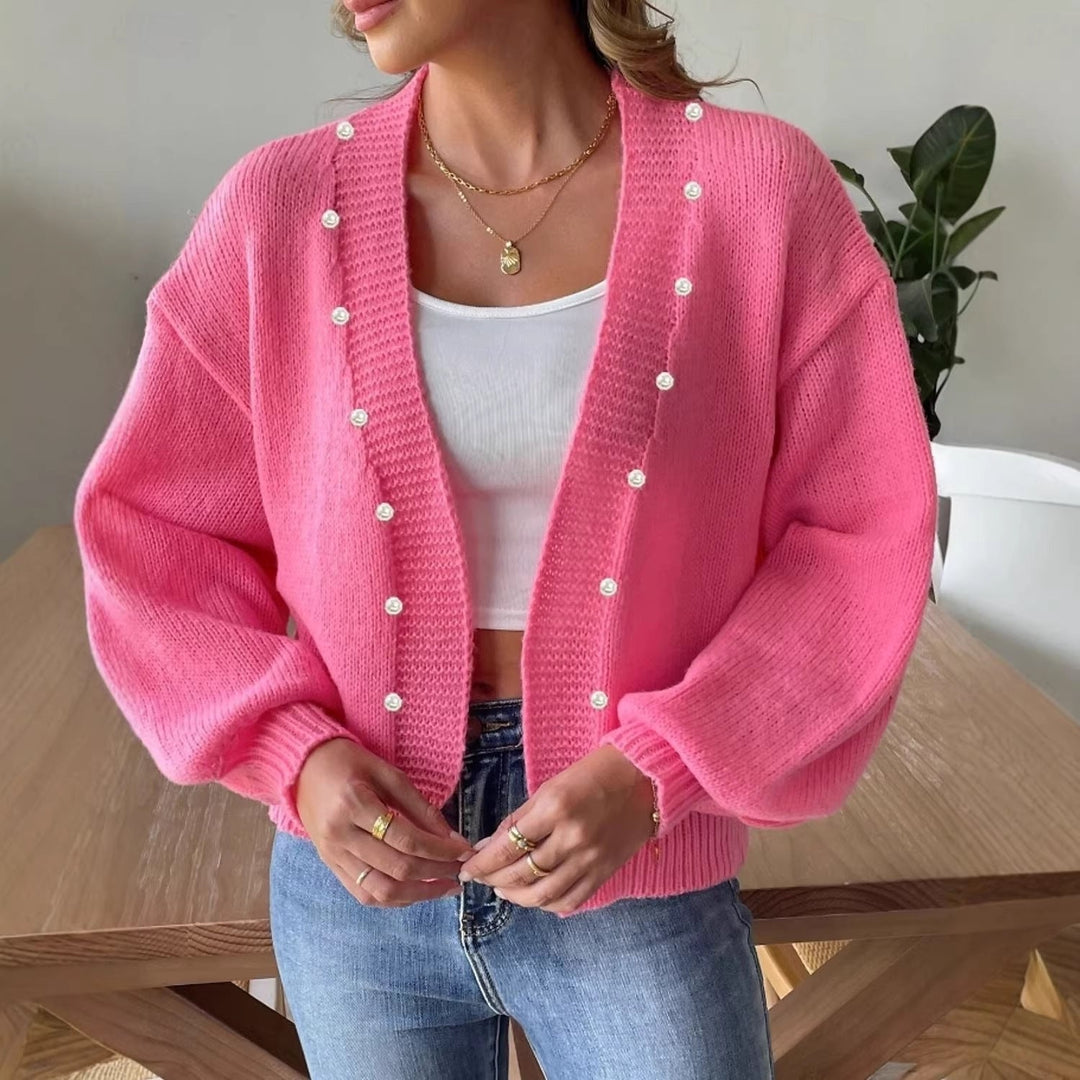 Damski kardigan oversize z perłowymi guzikami i bufiastymi rękawami. Wygodny i elegancki sweter na co dzień.