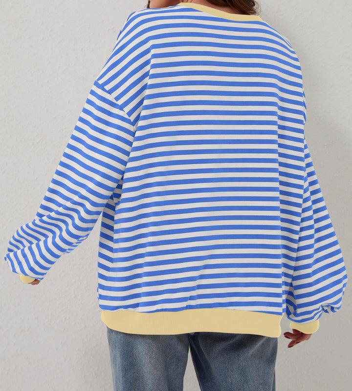 Modna damska bluza oversize w paski z okrągłym dekoltem. Wiosenno-jesienny, casualowy styl.