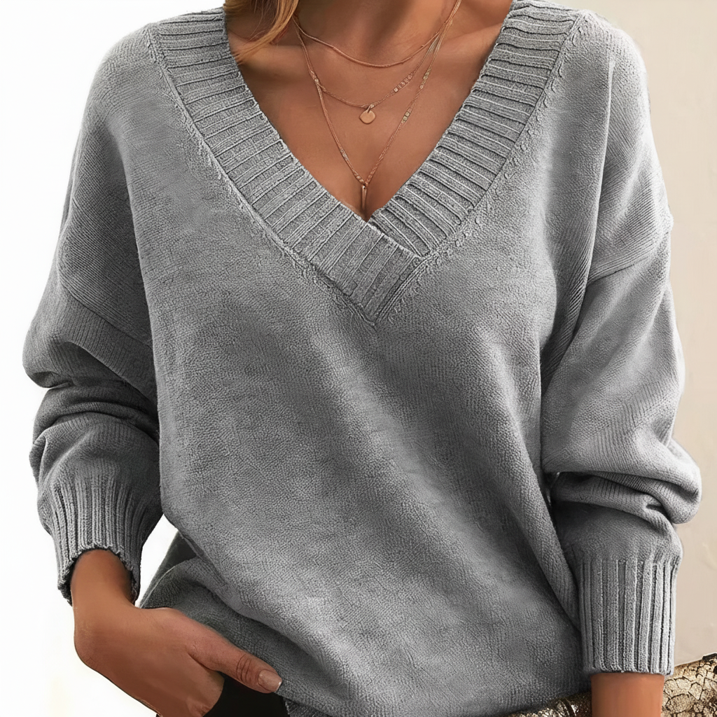 Miękki i przyjemny w dotyku damski sweter V-neck, komfortowy na chłodne dni, w klasycznym stylu.
