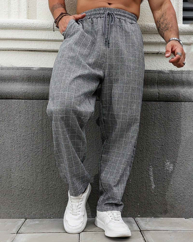 Męskie spodnie casual w szarą kratę. Prosta nogawka, elastyczny pas ze ściągaczem. Wiosenny look.