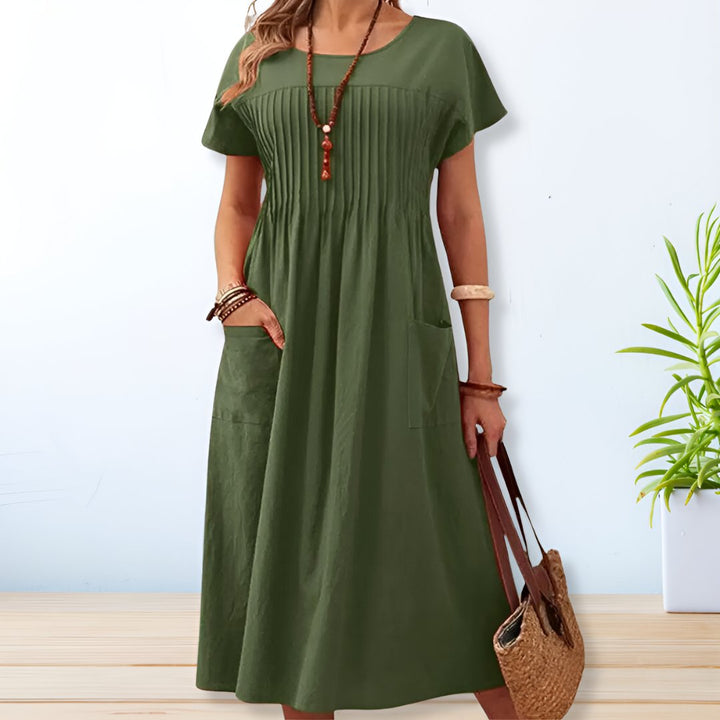 Damska plisowana sukienka maxi z kieszeniami, elegancka i komfortowa, idealna na lato i casualowe stylizacje.