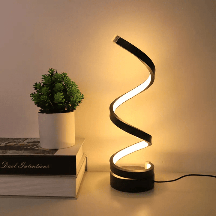 Nowoczesna lampka stołowa LED o spiralnym kształcie, energooszczędna. Designerskie oświetlenie wnętrz.
