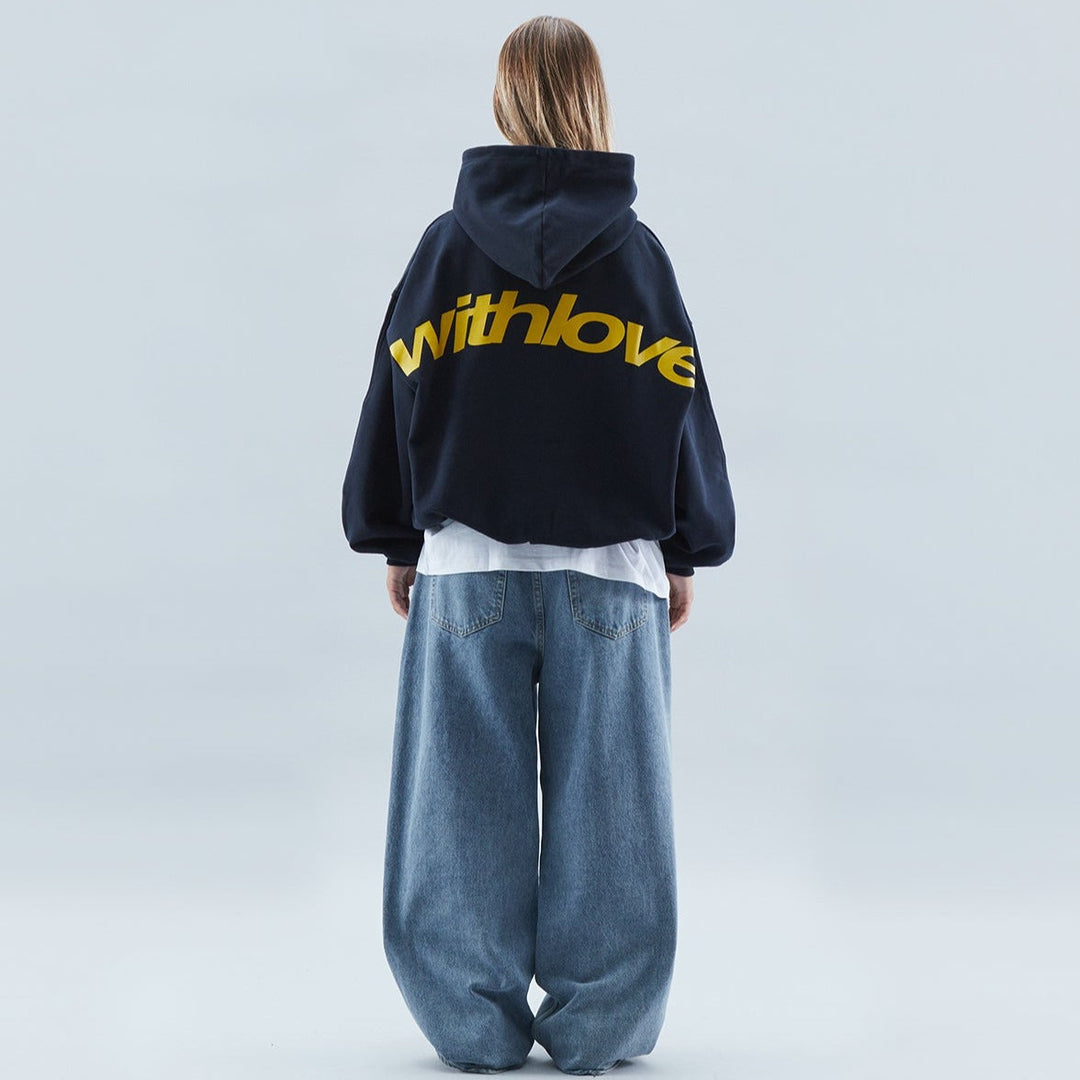 Niebieska bluza oversize damska z kapturem i modnym napisem, styl casual i streetwear.