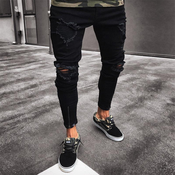 Czarne męskie jeansy slim fit z modnymi przetarciami, idealne do casualowych stylizacji miejskich.