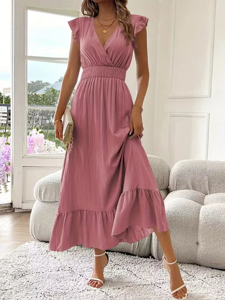 Modna damska sukienka maxi na wesele. Kopertowy dekolt, falbana. Elegancka, długa. Idealna na przyjęcie.