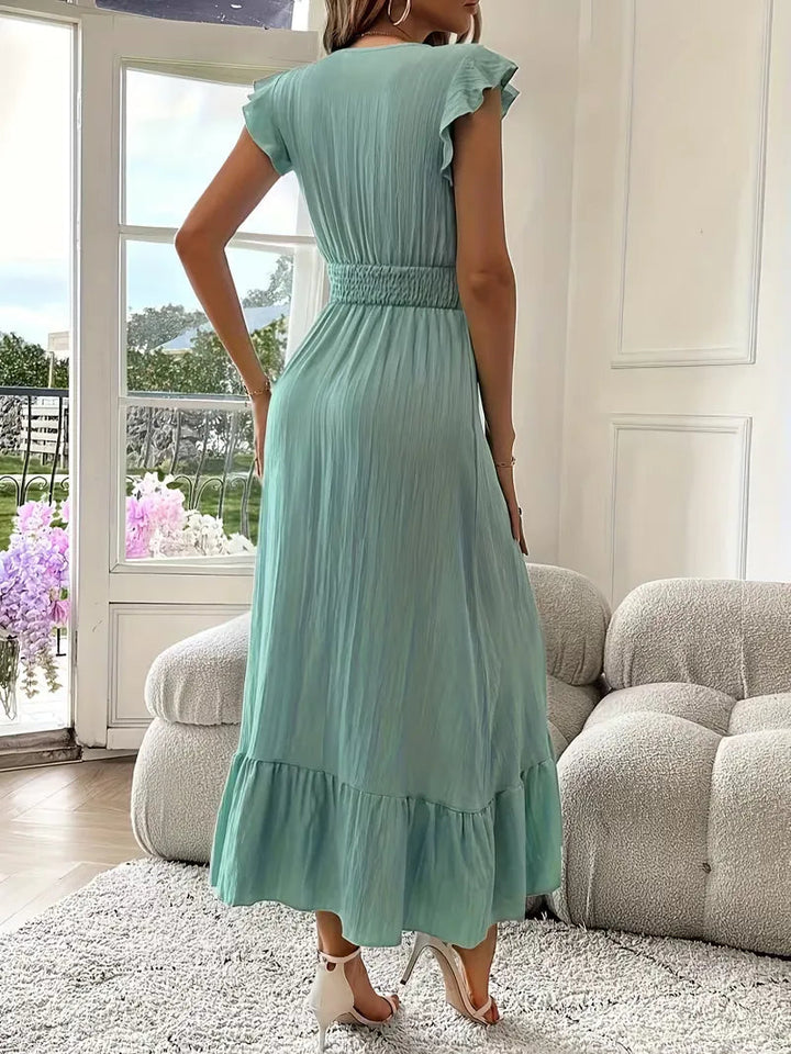 Modna długa sukienka wieczorowa na wesele, przyjęcie. Elegancka maxi z falbaną i kopertowym dekoltem.