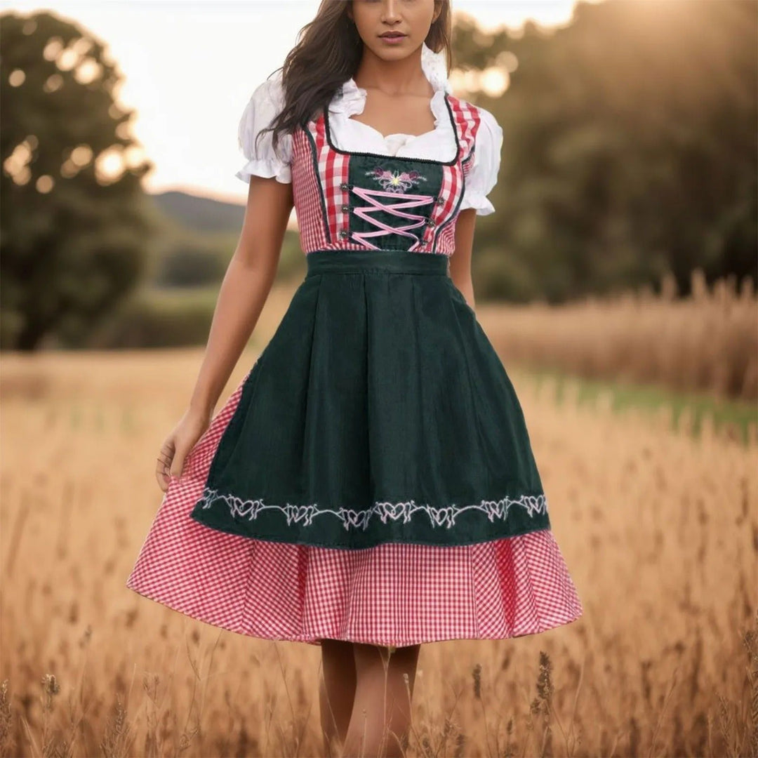 Damska zielona sukienka dirndl w kratę z czarnym fartuszkiem, idealna na Oktoberfest.